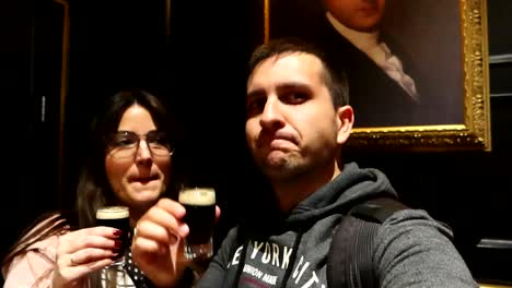 Portrait-of-couple-drinking-and-enjoying-small-glass-of-Guinness-beer