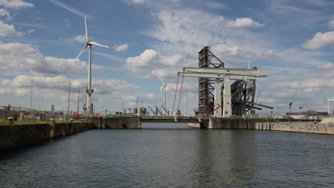 Wind-turbines-and-the-Building-of-Lillo-Bridge-at-the-Port-of-Antwerp,-Belgium---Wide-Shot