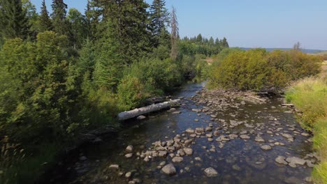 Aerial-Drone-Tracks-Stream-Along-Cariboo-Highway-near-127-Mile-House,-BC,-Canada