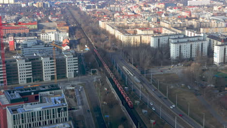Mineral-Wagon-Train-And-Traffic-Seen-From-Top-of-MOL-Campus-Towards-West-In-Budapest,-Hungary