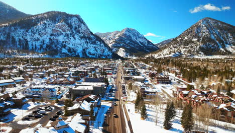 Winter-bluebird-sky-daytime-snowy-downtown-Frisco-aerial-drone-ten-mile-range-main-street-Colorado-mountain-ski-town-Copper-Ikon-Pass-Breckenridge-Silverthorne-Dillon-Summit-County-forward-pan-reveal