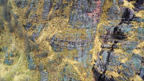 Colorful-rock-strata-with-intricate-patterns,-nature's-artistry-on-display,-aerial-view