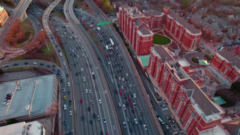 Aerial-view-of-traffic-on-highway-adjacent-to-residential-buildings-in-Atlanta,-Georgia-at-twilight
