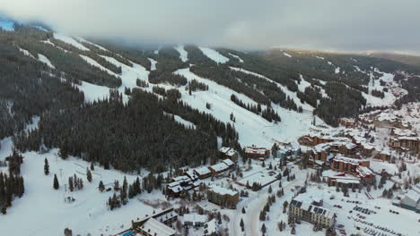 Sun-peaks-foggy-cloud-layer-winter-snowy-early-morning-sunrise-aerial-drone-Copper-Mountain-Colorado-ski-resort-i70-Eagle-Flyer-lift-east-village-snowboarding-half-pipe-Ikon-Epic-pass-forward-pan-up