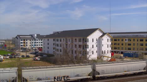 Drone-view-of-new-housing-construction-as-train-passes-by