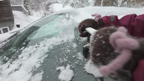 Person-Scraping-Ice-Off-Car-Windshield-In-Winter-Using-Scraper
