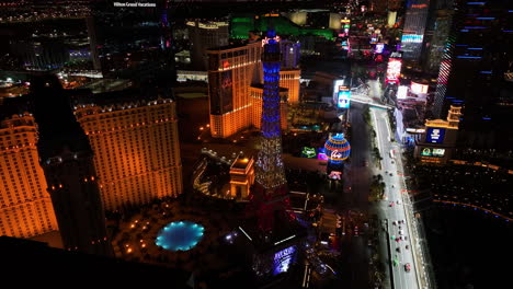 Aerial-view-circling-the-illuminated-Eiffel-Tower,-night-in-Las-Vegas,-USA