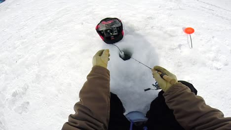 A-Fisherman-is-Utilizing-a-Flasher-While-Ice-Fishing---Close-Up