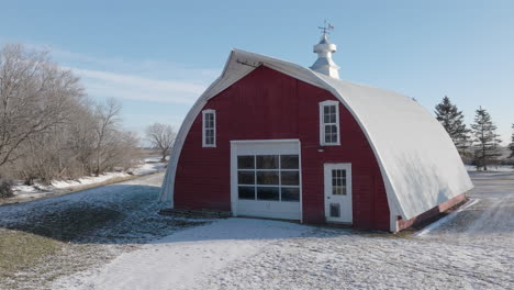 Snow-Covered-Red-Barn-with-Weather-Vane-in-Rural-Winter-Setting