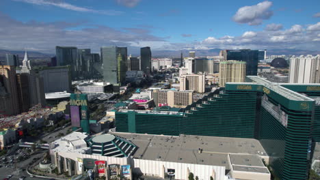 Las-Vegas-USA,-Aerial-View-of-Strip-Hotel-and-Casino-Buildings-Boulevard-Traffic-on-Sunny-Day,-Drone-Shot