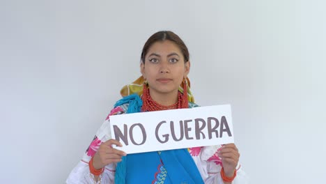 Cinematic-clip-of-a-young-brunette-latin-girl-wearing-the-traditional-outfit-named-Cayambeñas-showing-up-a-message-saying-"No-Guerra