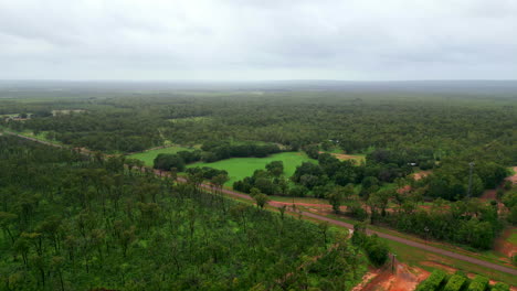 Aerial-drone-of-Rural-Outback-Estate-With-Quiet-Country-Road-and-Cloudy-Misty-Horizon,-Pullback