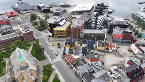 Drone-Shot-of-Tromso-Cathedral-and-Port,-Norway,-Landmark-and-Harbor-Buildings,-Norway