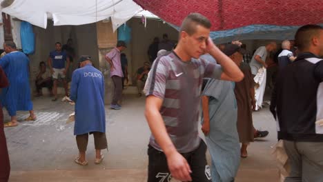 Leather-sellers-showcasing-their-products-to-attract-local-buyers-in-Fez,-Morocco