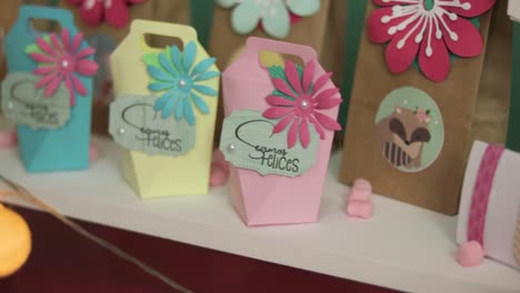 Paper-craft-present-boxes-with-text-in-Spanish-saying-"Let's-be-happy