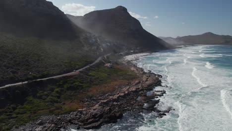 Mountain-Road-And-Ocean-Waves-In-Misty-Cliffs,-Cape-Town,-South-Africa---Aerial-Drone-Shot