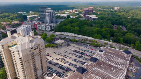 Parking-cars-on-parking-area-in-Buckhead-district-near-highway,-Atlanta