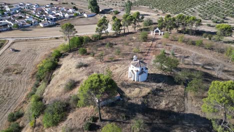 Aerial-of-the-sacred-La-Ermita-del-Poblado-de-San-Julián,-a-hallowed-sanctuary-that-beckons-pilgrims-and-travelers-alike-to-experience-its-profound-tranquility