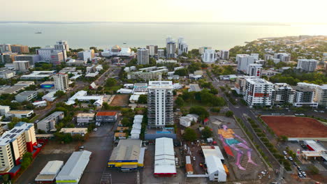 Luftdrohne-Mit-Großem-Menschengemälde-Bei-Sonnenuntergang-An-Der-Küste-Des-Zentralen-Geschäftsviertels-Von-Darwin,-Australien