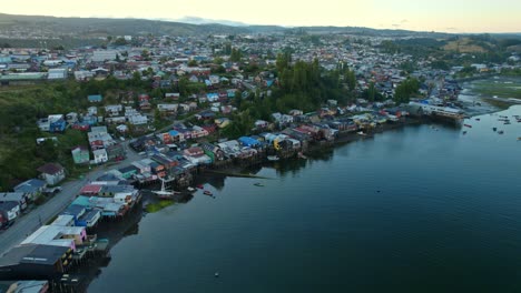 Aerial-view-around-the-Palafitos-stilt-houses-of-Castro-city,-sunset-in-Chiloe