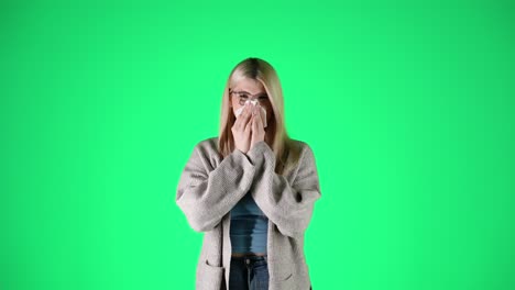 Concept-having-the-flu,-woman-sneezes-into-handkerchief,-green-background