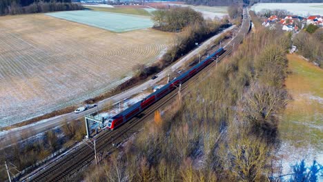 Red-Passenger-Train-Traversing-Through-Rural-Frosted-Countryside