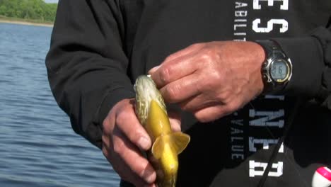 A-Man-With-a-Fish-in-Hand-by-the-Lake---Close-Up