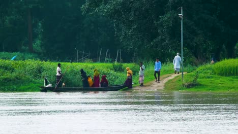 Villagers-are-crossing-a-river-in-a-wooden-boat-in-rural-Bangladesh