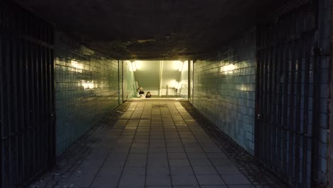 Subway-entrance-in-Stockholm-Sweden-with-two-people-approaching-g