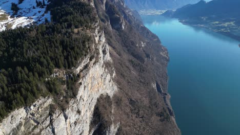Amden-Weesen-Switzerland-cliffs-along-lake-tilt-down-view