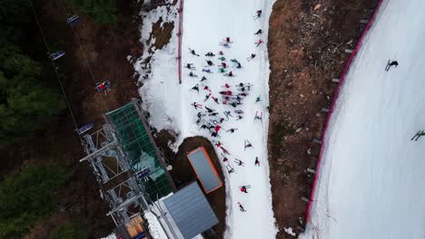 Aerial-top-down-view-of-skiers-gather-near-Dolni-Morava-chairlift-terminal