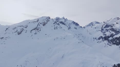 Drone-view-of-Snowy-Mountain-Range-Silhouette-Sunrise-Aerial-View