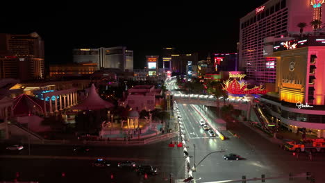 Aerial-view-flying-low-over-the-F1-light-fences-on-the-strip,-night-in-Las-Vegas