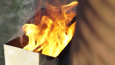 Blazing-fire-heating-a-branding-iron-in-slow-motion,-captured-in-a-close-up