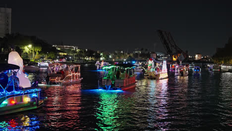 Boats-Slowing-Moving-Along-for-a-Christmas-Boat-Parade-with-Bright-and-Colorful-Lights-in-Tampa,-Florida