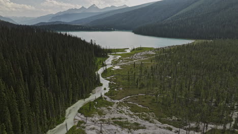 Emerald-Lake-BC-Canada-Aerial-v3-cinematic-drone-flyover-meandering-river,-water-flows-into-the-lake-surrounded-by-lush-coniferous-forests-and-mountain-valleys---Shot-with-Mavic-3-Pro-Cine---July-2023