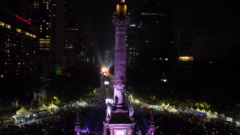 Aerial-view-in-front-of-the-El-Ángel-de-la-Independencia-statue,-night-in-Mexico-city