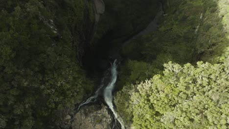 Birds-view-shot-of-a-long-waterfall-in-a-forest