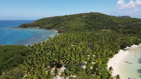 Pristine-tropical-island-in-Fiji-with-stunning-turquoise-water,-coral-reef,-palm-trees-and-white-sand-beaches