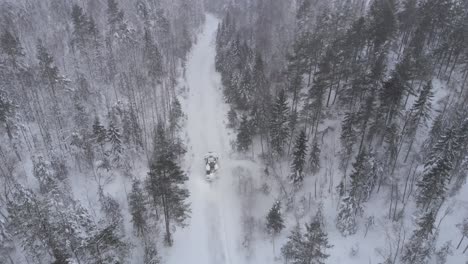 Snow-Plow-In-The-Forest-Full-Of-Snow---Aerial-Drone-Shot