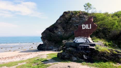 Scenic-landscape-view-of-Dili-Rock-landscape-on-white-sandy-beach-and-ocean-at-popular-dive-site-in-the-capital-city-of-East-Timor,-Southeast-Asia