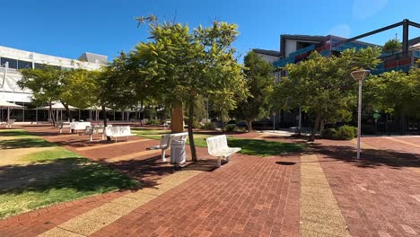 Handheld-shot-moving-through-the-landscaped-grounds-of-North-Metro-TAFE,-East-Perth