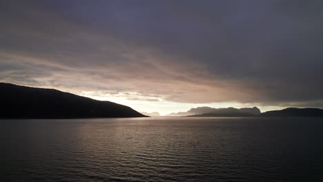 Panoramic-aerial-shot,-panning-across-a-sunset-over-Sognefjord-in-Norway