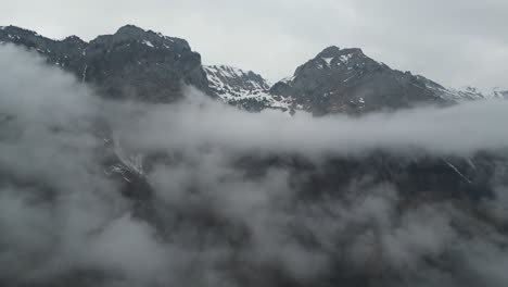 Klöntalersee-Glarus-Switzerland-flight-at-high-altitude-through-swiss-alps-clouds