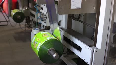 pov-shot-large-roll-of-chips-going-into-machine-and-large-machine-visible