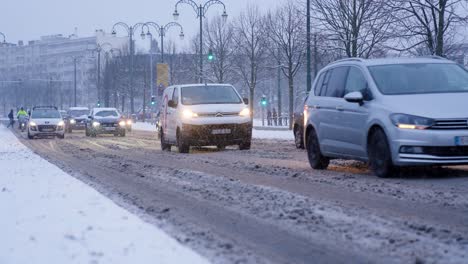 Traffic-In-The-Snowy-Road-During-Snowfall-In-Woluwe-Saint-Pierre,-Belgium