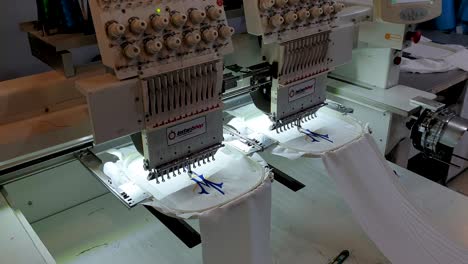 Close-up-of-computerized-embroidery-automated-machine-embroidering-pattern-from-software-design-onto-textile-fabric