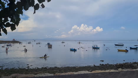 Sanur-Beach,-Bali-Island-at-Evening-on-Low-Tide,-People-and-Skyline,-Panorama