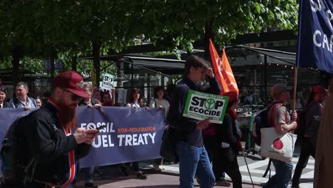 Protesters-with-Fossil-Fuel-Treaty-banner-at-climate-march,-slomo