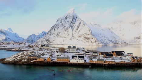 Kayaking-in-front-of-Sakrisoy-and-Olstinden-mountain-in-Lofoten,-Norway